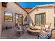 Inviting patio with a cozy fire pit, comfortable seating, and seamless indoor-outdoor living at 10649 E Saddle Blanket Trl, Gold Canyon, AZ 85118
