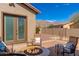 Charming patio featuring a stone fire pit, plush seating, and views of desert mountain vistas at 10649 E Saddle Blanket Trl, Gold Canyon, AZ 85118