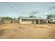 View of the home's spacious backyard with a covered patio and block fencing at 11509 E Marguerite Ave, Mesa, AZ 85208