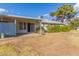 Backyard showcasing a covered patio, lush bushes, and an exterior view of the home at 11671 S Jokake St, Phoenix, AZ 85044