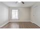 Bright bedroom featuring wood floors, closet, neutral paint, and a large window at 11671 S Jokake St, Phoenix, AZ 85044