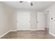 Bedroom features neutral walls, modern ceiling fan, and closet with sliding doors at 11671 S Jokake St, Phoenix, AZ 85044