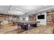 Well-lit billiards room with pool tables, bookshelves, and seating for community enjoyment at 11671 S Jokake St, Phoenix, AZ 85044
