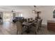 Beautiful dining room featuring a wooden table set for six guests with living room beyond at 11671 S Jokake St, Phoenix, AZ 85044