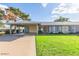 Charming single-story home with a covered carport, beautiful yard, and lush green lawn, offering a cozy suburban lifestyle at 11671 S Jokake St, Phoenix, AZ 85044