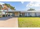 Charming single-story home featuring a covered carport, fresh green grass and mature shade tree at 11671 S Jokake St, Phoenix, AZ 85044
