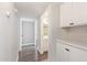 Hallway featuring clean white paint, updated doors, and matching white cabinets with dark hardware at 11671 S Jokake St, Phoenix, AZ 85044