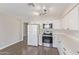 Updated kitchen featuring stainless steel appliances, granite countertops, and wood-look flooring at 11671 S Jokake St, Phoenix, AZ 85044