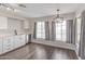Bright kitchen area with stainless steel appliances, light wood floors, and a modern light fixture at 11671 S Jokake St, Phoenix, AZ 85044