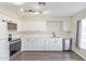 Efficient kitchen with white cabinets, stainless steel appliances, and modern track lighting at 11671 S Jokake St, Phoenix, AZ 85044