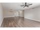 Bright living room featuring wood-look floors, ceiling fan and ample space at 11671 S Jokake St, Phoenix, AZ 85044