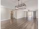 Spacious living room featuring hardwood floors, modern lighting, and slider doors to the patio at 11671 S Jokake St, Phoenix, AZ 85044