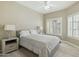 Serene bedroom with a neutral palette, wood floors, and natural light from plantation shuttered window at 14000 N 94Th St # 2144, Scottsdale, AZ 85260