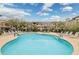 Community pool surrounded by lounge chairs and lush landscaping at 14000 N 94Th St # 2144, Scottsdale, AZ 85260