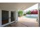 View of the covered back patio with outdoor access to the pool and garden with bright-colored flowers at 14401 N 22Nd St, Phoenix, AZ 85022