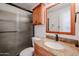 Bathroom featuring a granite vanity, framed mirror, and tiled shower at 14401 N 22Nd St, Phoenix, AZ 85022