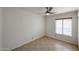 Cozy bedroom with neutral walls, tile floor, and window letting in natural light at 14401 N 22Nd St, Phoenix, AZ 85022