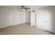 Large bedroom featuring tile floors, neutral walls, and ample closet space at 14401 N 22Nd St, Phoenix, AZ 85022
