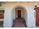 Close-up view of arched front entry with security door and well-maintained facade at 14401 N 22Nd St, Phoenix, AZ 85022