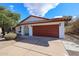 Inviting single-story home featuring a red tile roof and a spacious two-car garage at 14401 N 22Nd St, Phoenix, AZ 85022