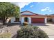 Charming single-story home featuring a red tile roof, landscaped yard, and a two-car garage at 14401 N 22Nd St, Phoenix, AZ 85022