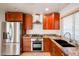 Kitchen featuring stainless steel appliances, a gas range, granite countertops, and wood cabinetry at 14401 N 22Nd St, Phoenix, AZ 85022