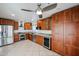 Bright kitchen with stainless steel appliances, wood cabinets, tile floors, and a ceiling fan at 14401 N 22Nd St, Phoenix, AZ 85022