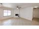Spacious living area with neutral tile floors, a white brick fireplace, and ample natural light at 14401 N 22Nd St, Phoenix, AZ 85022