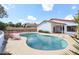 Backyard pool with tiled edge, patio area, and lush landscaping set against a sunny sky at 14401 N 22Nd St, Phoenix, AZ 85022