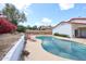 Sparkling backyard pool and patio area with desert landscaping, lounge chairs, and privacy fence at 14401 N 22Nd St, Phoenix, AZ 85022