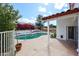 Backyard pool surrounded by lush landscaping and flowers with a view to the attached covered patio at 14401 N 22Nd St, Phoenix, AZ 85022