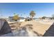 Desert backyard with a mix of landscaping, a block fence, mature trees, and covered patio area at 1621 W Mulberry Dr, Phoenix, AZ 85015