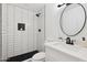 This bathroom has a modern vanity, updated fixtures, and a stand-up shower with sleek tiling and black accents at 1621 W Mulberry Dr, Phoenix, AZ 85015