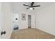 Bright bedroom with carpet flooring, ceiling fan, and access to ensuite bathroom at 1621 W Mulberry Dr, Phoenix, AZ 85015