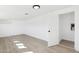 Bright bedroom featuring light wood flooring, white walls, and an open door to an adjacent space at 1621 W Mulberry Dr, Phoenix, AZ 85015
