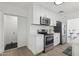 Modern kitchen with white cabinets, stainless steel appliances, and sleek countertops at 1621 W Mulberry Dr, Phoenix, AZ 85015