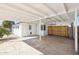 Covered patio providing shade and a transition to the backyard space, including a wooden gate at 1621 W Mulberry Dr, Phoenix, AZ 85015