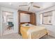 Bright bedroom with Murphy bed offers a versatile space with a ceiling fan and ample natural light at 17200 W Bell Rd # 77, Surprise, AZ 85374