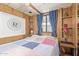 Cozy bedroom offers wood paneled walls, built-in shelving, and a comfortable bed with blue accents at 17200 W Bell Rd # 77, Surprise, AZ 85374
