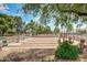 Bocce ball court surrounded by mature trees, benches, and landscaping at 17200 W Bell Rd # 77, Surprise, AZ 85374