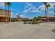 Exterior view of building surrounded by palm trees and desert landscape with a blue sky backdrop at 17200 W Bell Rd # 77, Surprise, AZ 85374