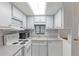 Well-maintained kitchen with white cabinets, appliances, and a window offering natural light at 17200 W Bell Rd # 77, Surprise, AZ 85374
