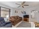 Cozy living room with plush seating, ceiling fan, and ample natural light for a comfortable atmosphere at 17200 W Bell Rd # 77, Surprise, AZ 85374