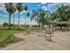 Outdoor seating area with tables and chairs, surrounded by lush greenery and palm trees at 17200 W Bell Rd # 77, Surprise, AZ 85374