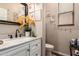 Bathroom featuring a white vanity, modern fixtures, mirror, and tasteful decor at 17541 W Statler Dr, Surprise, AZ 85388