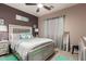 Cozy bedroom features a decorative silver bed frame and neutral tones with a ceiling fan at 17541 W Statler Dr, Surprise, AZ 85388