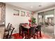 Modern dining area with a sleek table, matching chairs and access to the outdoor patio at 17541 W Statler Dr, Surprise, AZ 85388
