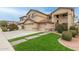 Beautiful two-story home boasting a well-maintained front yard, three-car garage, and inviting entrance at 17541 W Statler Dr, Surprise, AZ 85388