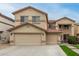 Two-story home featuring a well-manicured lawn and a spacious three-car garage adding to the inviting curb appeal at 17541 W Statler Dr, Surprise, AZ 85388
