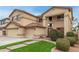 Inviting home featuring a beautifully landscaped front yard, spacious driveway, and attached garage, creating a warm and welcoming atmosphere at 17541 W Statler Dr, Surprise, AZ 85388